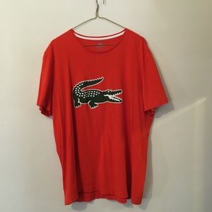 Orange Lacoste tee with big logo